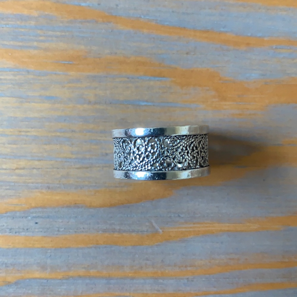 Sterling silver ring with ornate cutouts.